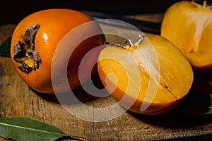 Kaki or persimmons  fruits on a old wooden background