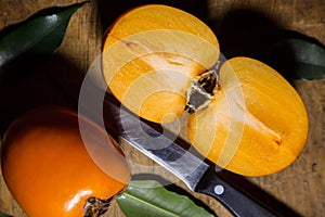 Kaki or persimmons  fruits on a old wooden background