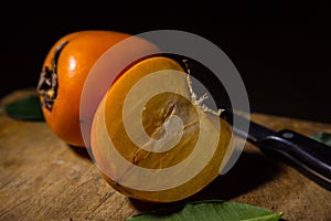 Kaki or persimmons  fruits on a old wooden background