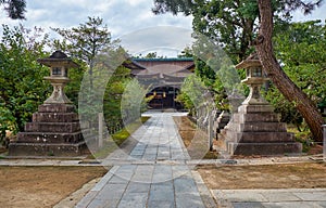 A kaku-doro  square stone lanterns along the pass at Kitano Tenmangu shrine. Kyoto. Japan