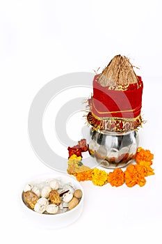 Kalash with coconut and chunni with floral decoration for navratri pooja. Picture of dry fruit in the bowl