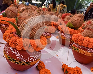 Kalash with coconut and mango leaf with floral decoration earthen pots containing sacred water. Kalash for hindu puja during