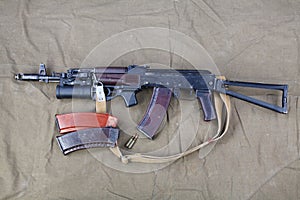 Kalashnikov AK 74 with underbarrel grenade launcher and ammunitions on canvas