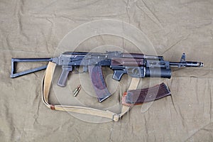 Kalashnikov AK 74 with underbarrel grenade launcher and ammunitions on canvas