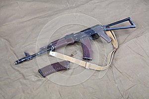Kalashnikov AK 74 with ammunitions on canvas photo