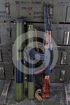 Kalashnikov AK47 gun and `Bazooka` RPG grenade launchers in army green crate