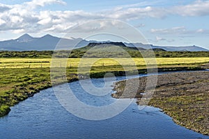 Kalda river flow in western Iceland and Eldborg volcano crater in the center of picture photo