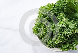 Kale in bowl on marble background. curly kale