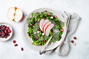 Kale salad with dried cranberry, hazelnuts and sliced apple.