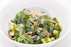 Kale salad in white bowl on white