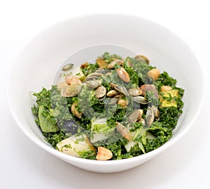 Kale salad in white bowl on white
