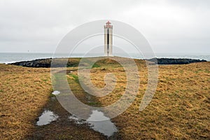 Kalfshamarsvik lighthouse in the western part of Iceland during rainy weather.