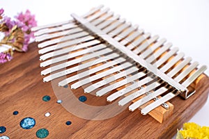 Kalimba or Mbira is an African musical instrument close up on white background. Music concept