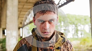 Kaliningrad, Russia - August, 2019:Young soldier in military uniform remove cloth mask on his face and look at the