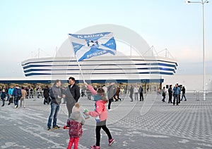 KALININGRAD, RUSSIA. The girl waves a flag of ffootball club Baltika against the background of Baltic Arena stadium