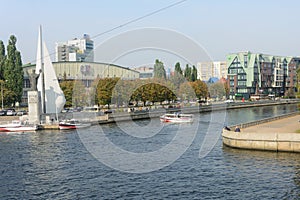 Kaliningrad, Russia - September 2020: Embankment on Pregolya river. Monument to fishermen and Nicholas Wonderworker. Pleasure