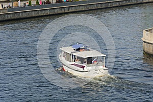 Kaliningrad, Russia - September 2020: White pleasure boat on Pregolya river. Tourist route, excursions by water