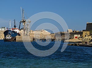 KALKARA, MALTA - Apr 19, 2014: Ship tank cleaning facility industry in Rinella Bay, Kalkara, part of Fort Ricasoli, Malta