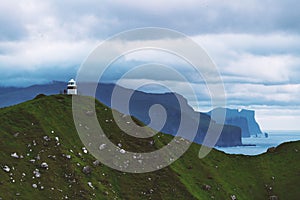 Kallur lighthouse on green hills of Kalsoy island