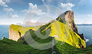 Kallur lighthouse on green hills of Kalsoy island