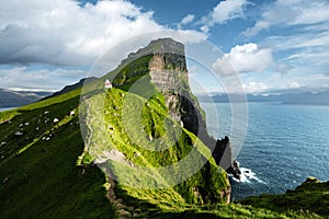 Kallur lighthouse on green hills of Kalsoy island