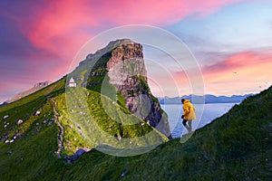 Kallur lighthouse on green hills of Kalsoy island