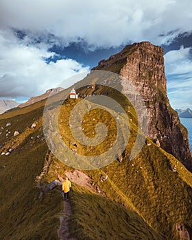 Kallur lighthouse on green hills of Kalsoy island