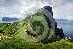 Kallur lighthouse on green hills of Kalsoy island, Faroe islands, Denmark. Landscape photography