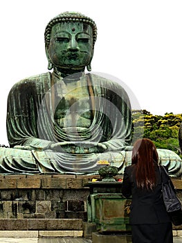 Kamakura, Kanagawa, KÃÂtoku-in / Japan: Back view of a woman dressed in black praying in front of the Great Buddha