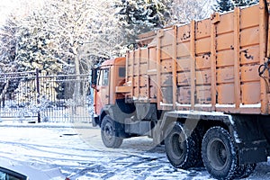 Kamaz of orange color stands in the snow in winter