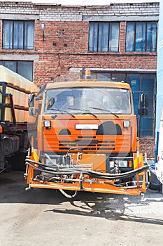 Kamaz truck stands in the parking on brick building background