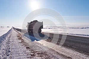 Kamaz truck on winter road and trees under snow in Altai