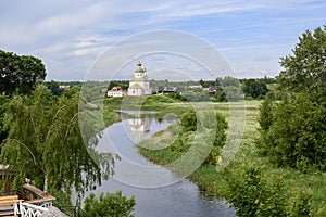 Kamenka River, Ilyinsky Church built in 1744 and blooming meadows in summer in Suzdal, Russia