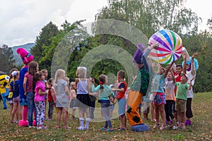 Animators entertain children on the feast day of the village of Kamennomostskiy in the autumn Park