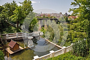 Kamianets-Podilskyi cityscape with swan lake in city park, Ukraine