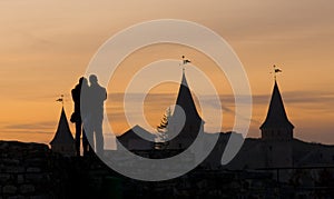 Kamianets-Podilskyi: couple in love at sunset