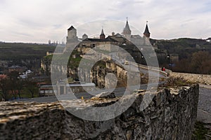 Kamianets-Podilskyi, Ukraine. Panoramic view of the Castle bridge to Kamianets-Podilskyi fortress on a cloudy winter day