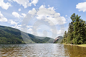 KAMLOOPS, CANADA - JULY 08, 2020: Paul Lake Summer time with green mountains and white clouds british columbia canada