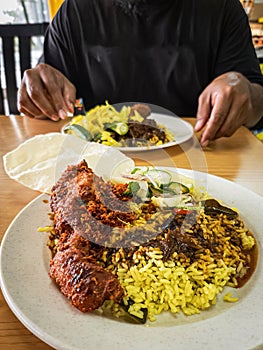 Kandar rice, famous Indian - Malay fusion food served with deep-baked fried chicken, vegetables and papadum