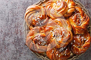 Kanelbullar or Kanelbulle is a traditional Swedish cinnamon buns flavored with cinnamon and cardamom spices and topped with pearl