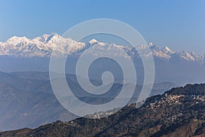 Kangchenjunga mountain in the morning with blue and orange sky and mountain villages that view from The Tiger Hill in winter