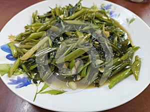 Kangkung Vegitable with plate on the table