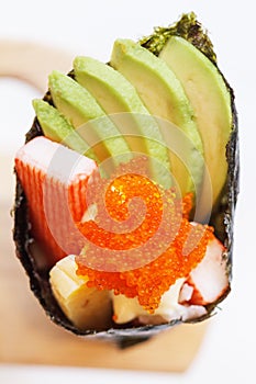 Kani with Avocado, Tamago Yaki Japanese Fried Egg and Ebiko Prawn Egg Tempura California or Temaki Sushi Hand Roll.