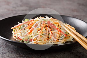 Kani salad is a Japanese style seafood salad made with crab stick closeup in the plate. Horizontal