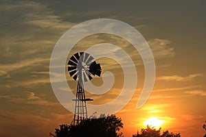 Kansas colorful Sunset with yellow and orange sky with a Windmill silhouette