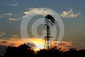 Kansas colorful Sunset with yellow and orange sky with a Windmill silhouette