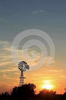 Kansas colorful Sunset with yellow and orange sky with a Windmill silhouette