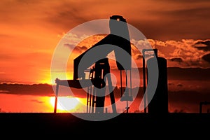 Kansas Oilwell Pump at Sunset with a colorful sky photo