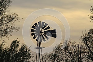 Kansas Windmill Sunset with clouds and Trees