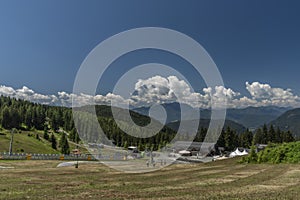 Kanzelhohe hill with cable cars and hotels in sunny fresh summer day